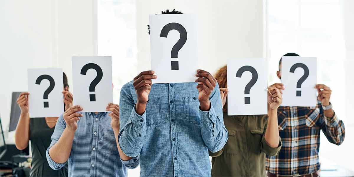Multiple people holding a white sheet of paper in front of their faces while exploring common ownership options